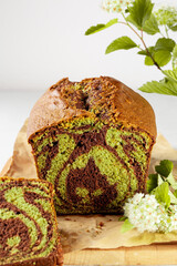 Sticker - Marble plumcake with chocolate and tea matcha. Selective focus. White background. Copy space. Close up.
