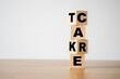  Flipping of take care yourself wording which print screen on wooden cubes blocks on table.