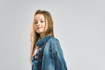 Portrait of a pretty little girl. child in a denim suit. Studio photography