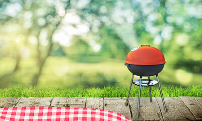 Wall Mural - barbecue grill on backyard and wooden table