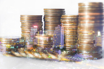 double exposure of city with row of coin stack for business investment finance banking and money saving concept.