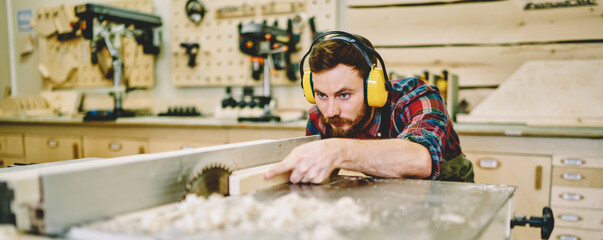 Wall Mural - craftsman concentrated on carpentry work with wooden using circular for decorative plank, skilled ma