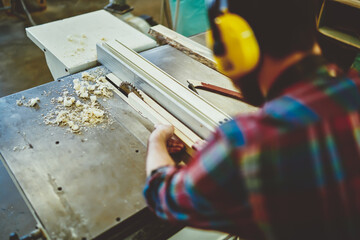 Wall Mural - cropped image of professional male craftsman working on decorative plank during diy hobby with wood 