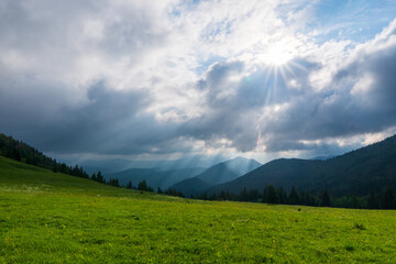 Wall Mural - the sun pierces through the clouds, shines on the slopes of the mountains, little fatra mountains. Slovakia Europe.