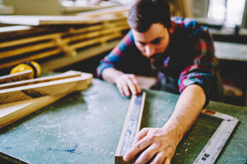 Wall Mural - selective focus on ruler measures wooden planks details of furniture construction standing on workin