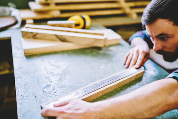Wall Mural - cropped image of caucasian male student of handmade carpentry courses measure details with ruler on 
