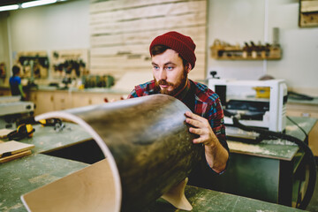 Wall Mural - skilled hipster guy working on making handmade construction on engineering on plane courses, profess