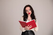 © fasli - young woman with diary. project manager. business school teacher or student isolated on the gray background
