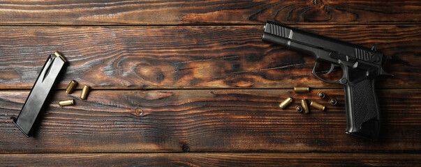 Wall Mural - Pistol, bullets and magazine on wooden background