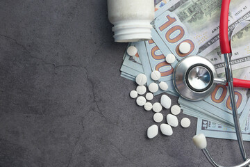 Wall Mural - Healthcare cost concept with us dollar and pills on black background.