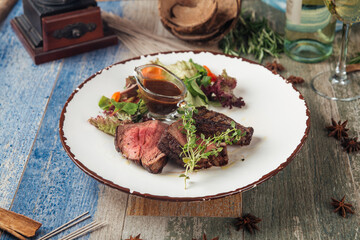 Wall Mural - Tender steak mignon with greens and sauce