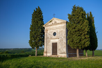 Wall Mural - A vertical shot of the famous historic Chapel Vitaleta in the middle of a field in Italy