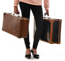 young girl with an old suitcases isolated on a white background