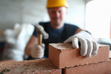 Close Up Of Male Builder Hands Using Hammer While Building Masonry Construction