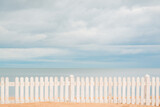 Fototapeta  - Wooden Fence in Sand on Beach.