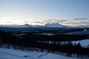 Snow covered mountains and forest in january in Norway