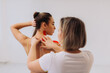 © dsheremeta - Physical therapist placing kinesio tape on woman patient's shoulder and neck