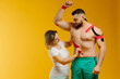 © dsheremeta - Therapeutic tape on mans shoulder. Female medical doctor explaining to athlete how kinesiology tape works.