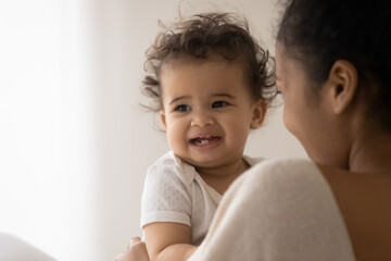 Wall Mural - head shot portrait happy cute toddler african american girl, loving young mother holding affectionat
