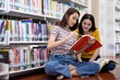 © PK Studio - University students in the library.Asian university student group researches in libraries