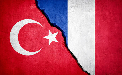 Wall Mural - Turkey and France conflict. Country flags on broken wall.