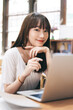© dodotone - Young asian woman teenager online learning at home via internet computer
