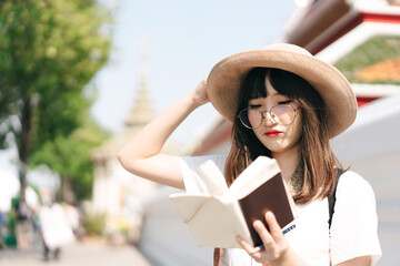 Wall Mural - Young asian cute glasses teenager girl traveller backpack solo local travel with memo written daily.