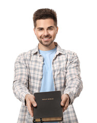 Wall Mural - Young man with Bible on white background