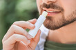 © Pixel-Shot - Handsome young man with lip balm outdoors, closeup