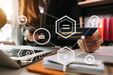 
Close up of hand using tablet ,laptop, and holding mobile phone with credit card online banking payment communication network, internet wireless application development sync app, virtual graphic  ico