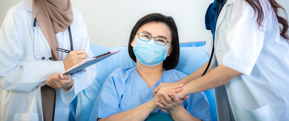 Wall Mural - Female adult patients lie in hospital, a doctor examining the health