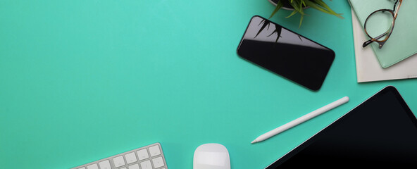 Copy space on creative worktable with digital devices and decoration