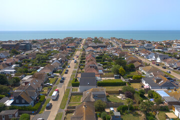 Wall Mural - Aerial photo of  Peacehaven on the East Sussex coast looking towards the English Channel on a warm and sunny summers day.