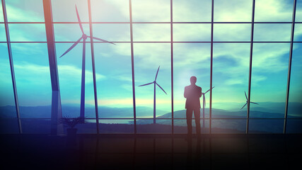 Wall Mural - in a spacious office against the window, a man looks at wind turbines.