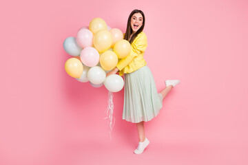 Poster - Full length body size view of her she nice-looking attractive lovely glad cheerful cheery girl holding in hands air balls chill out rest isolated on bright vivid shine vibrant yellow color background