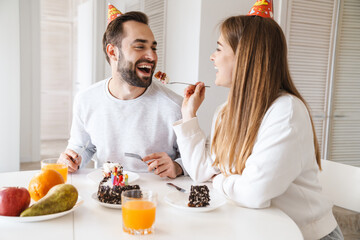 Wall Mural - Cheerful attractive young couple celebrating birthday