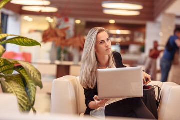 Wall Mural - Young successful purposeful attentive business woman for meeting in restaurant with investors or business partners. Discussion of project, advertising and promotion. Work on laptop anywhere remotely.