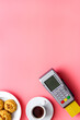 © 9dreamstudio - Payment by credit card. Terminal on pink restaurant desk from above copy space
