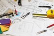 © Angelov - Architect's workspace with rolled house plans and blueprints