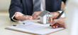 © sarawutnirothon - Signing a loan for a home purchase.