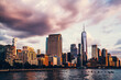 Panoramic view of Manhattan Island with modern buildings and Hudson river. Scenery skyline view of contemporary glass skyscrapers of downtown financial district in New York. Dramatic sky over city
