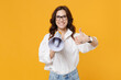 Smiling young business woman in white shirt glasses isolated on yellow wall background studio portrait. Achievement career wealth business concept. Mock up copy space. Hold megaphone showing thumb up.
