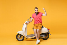 Screaming Young Bearded Man Guy In Casual Summer Clothes Standing Near Moped Isolated On Yellow Background Studio Portrait. Driving Motorbike Transportation Concept. Mock Up Copy Space Clenching Fist.