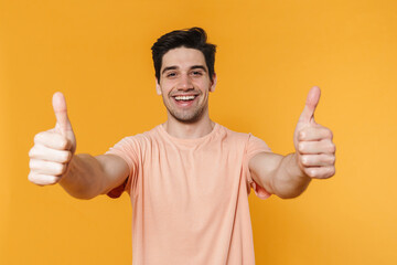 Poster - Photo of happy handsome man showing thumbs up and smiling