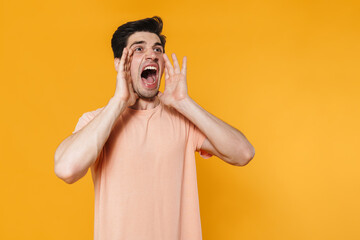 Canvas Print - Photo of furious handsome man screaming with throwing up hands