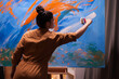 © DC Studio - Woman relaxing painting in art studio on large canvas. Modern artwork paint on canvas, creative, contemporary and successful fine art artist drawing masterpiece