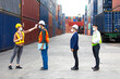 © NVB Stocker - Temperature measurement with employee temperature meter before entering work at container yard. People working on the import and export concept. Professional engineering team.