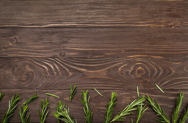 Canvas Print - Fresh rosemary sprigs on rustic kitchen table