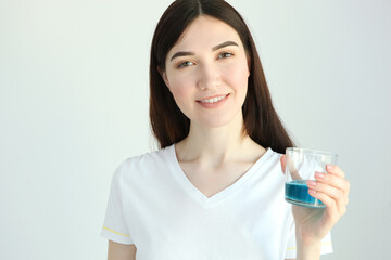 Wall Mural - young girl uses mouthwash at home
