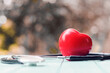 red heart and stethoscope on the table